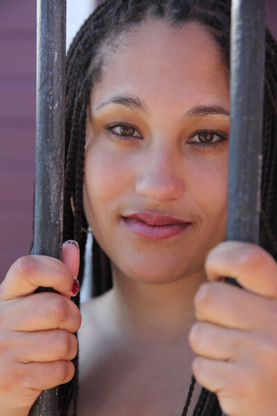 beautiful face trapped behind bars