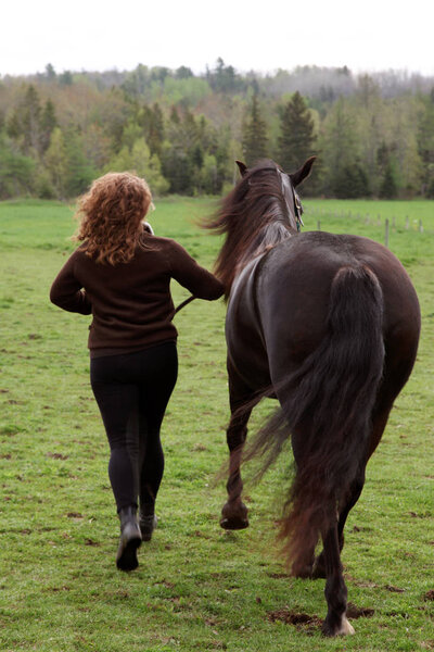 woman running away with horse 