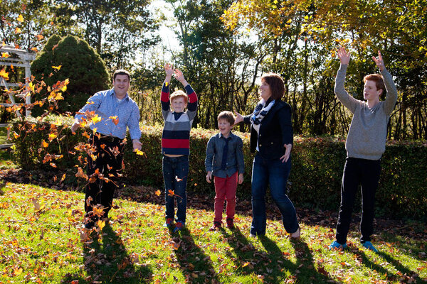 family playing in the fall 