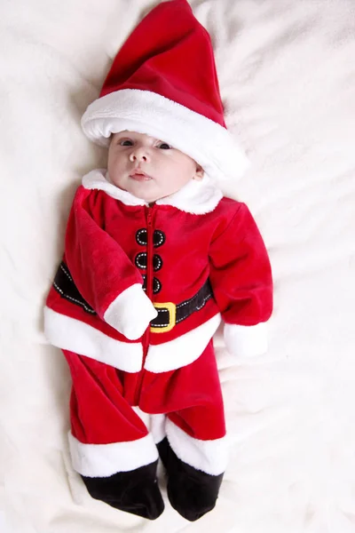 Tiny newborn in santa claus suit — Stock Photo, Image