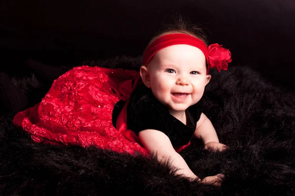 Newborn in red dress — Stock Photo, Image