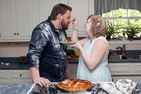 wife feeds husband pie