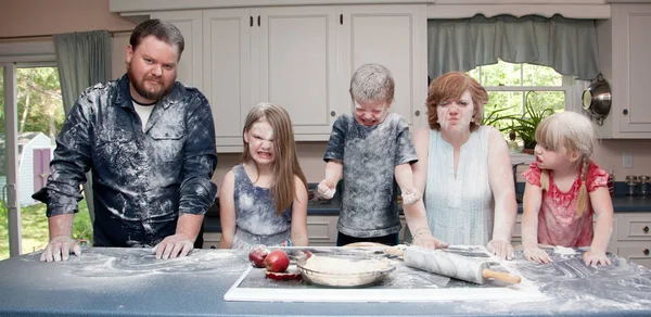 Family in the kitchen after food fight — Stock Photo, Image