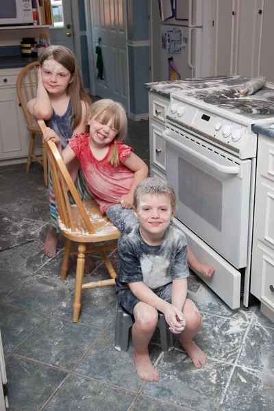 Naughty children mess in kitchen