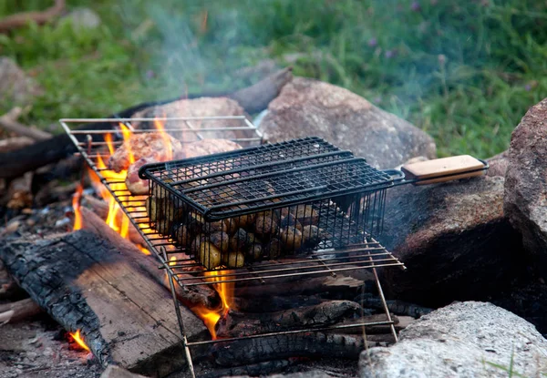food cooking on a campfire