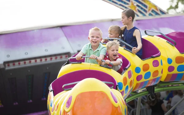 Dzieci na ekscytującą przejażdżkę roller coaster w parku rozrywki — Zdjęcie stockowe