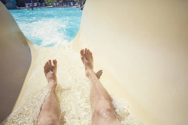 Riding down a slide at a waterpark resort — Stock Photo, Image