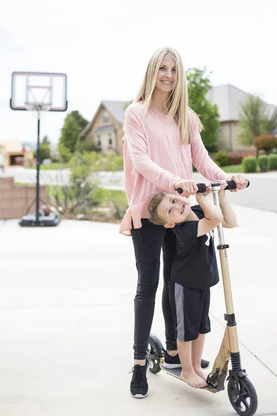 Cute Young Mother Her Little Boy Playing Together Scooter Driveway — Stock Photo, Image
