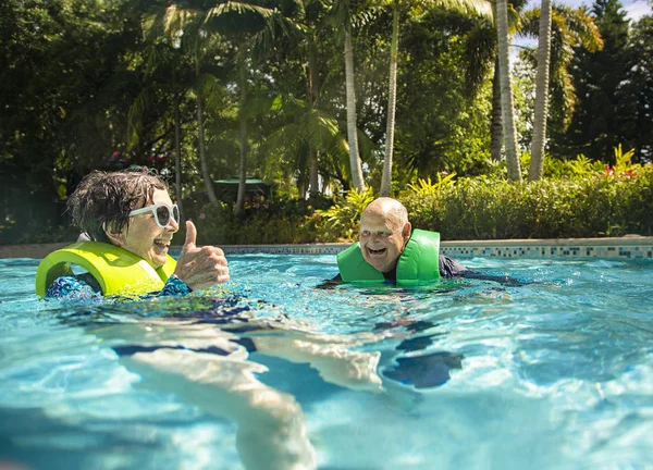 Senior Couple Splashing Playing Having Fun Water Park Smiling Pasar — Foto de Stock