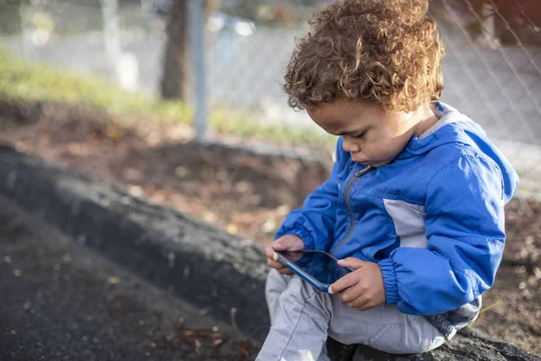 Young Diverse Boy Using His Parent Smartphone Park Outdoors Sitting — Stock Photo, Image
