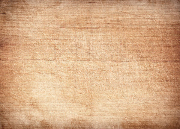Light brown scratched wooden cutting board. Wood texture