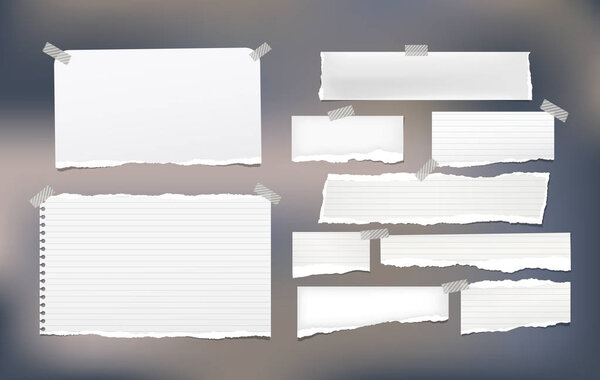 Pieces of torn white lined and blank note, notebook paper strips for text stuck with sticky tape on colorfu background.