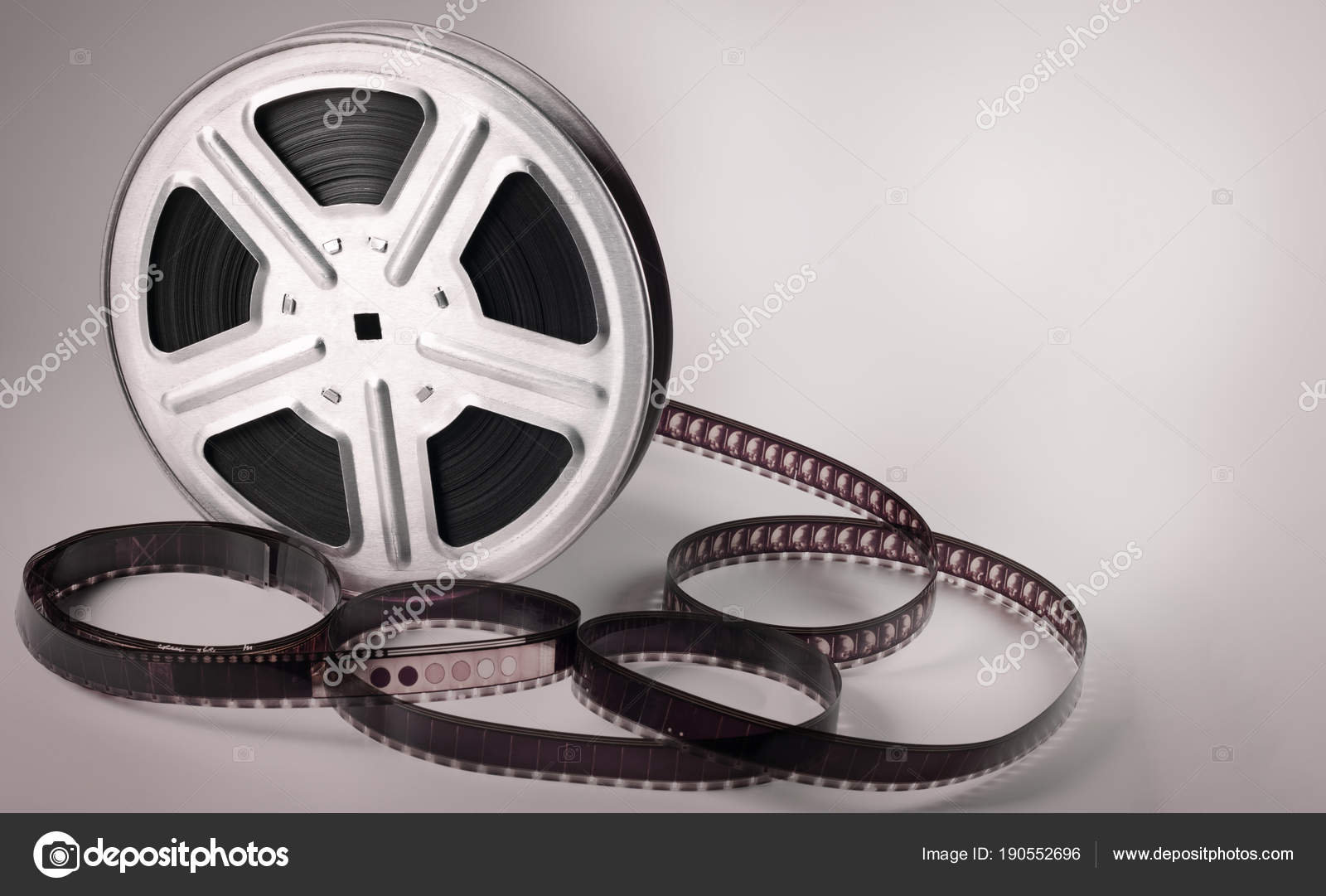 Old motion picture film reel on brown background — Stock Photo