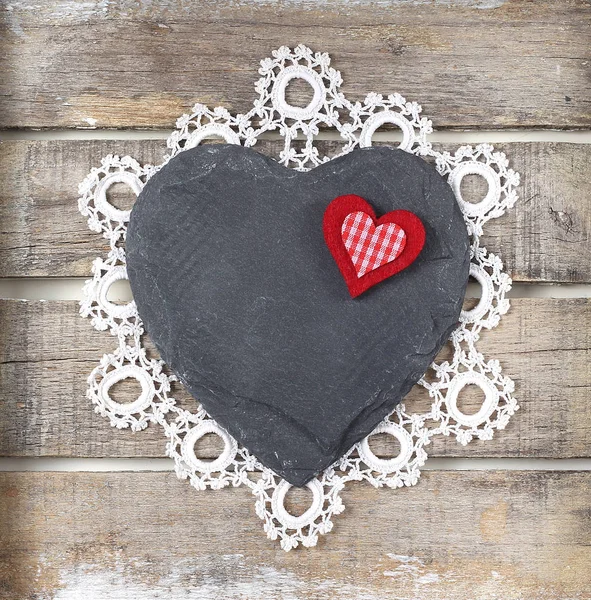 Stone heart on wooden background — Stock Photo, Image