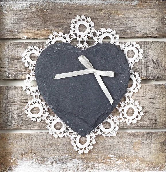 Stone heart on wooden background — Stock Photo, Image