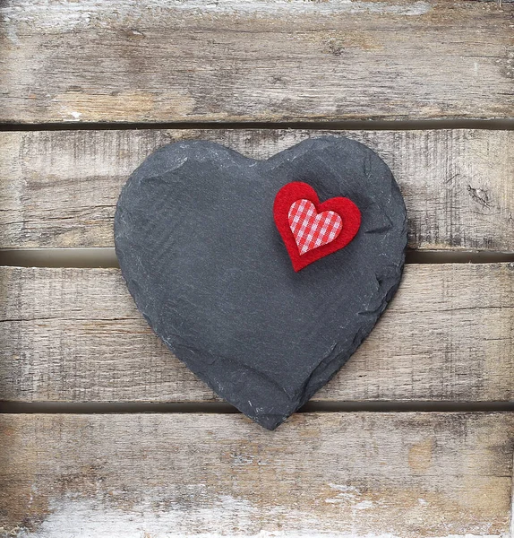 Stone heart on wooden background — Stock Photo, Image