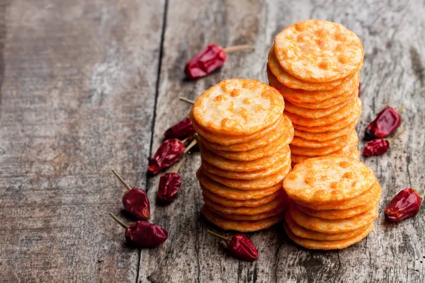 Round  shape rice cracker with chili pepper on wooden table — Stock Photo, Image