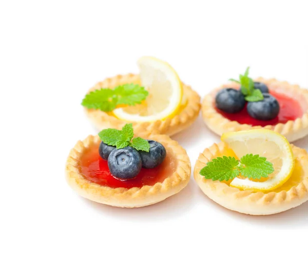 Set  of tasty tartlets with lemon and raspberry jam isolated — Stock Photo, Image