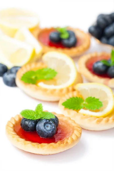 Set  of tasty tartlets with lemon and raspberry jam isolated — Stock Photo, Image
