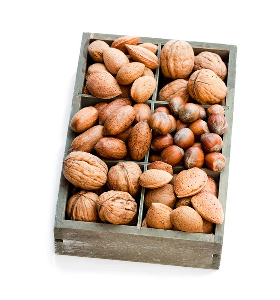 Various  nuts in wooden box isolated on white — Stock Photo, Image
