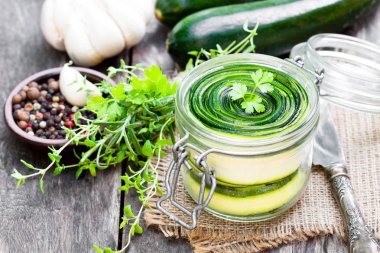 Maydanoz ve sarımsak ile dilimlenmiş kabak cam kavanoza korur 