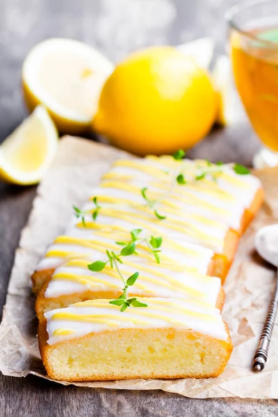 Lemonloaf torta sütés papírt zöld gyógynövény tea szeletelve — Stock Fotó