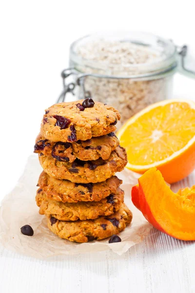 Homemade  pumpkin and orange cookies on white background