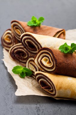 Süt ve çikolata krep siyah taş zemin üzerine haddelenmiş 