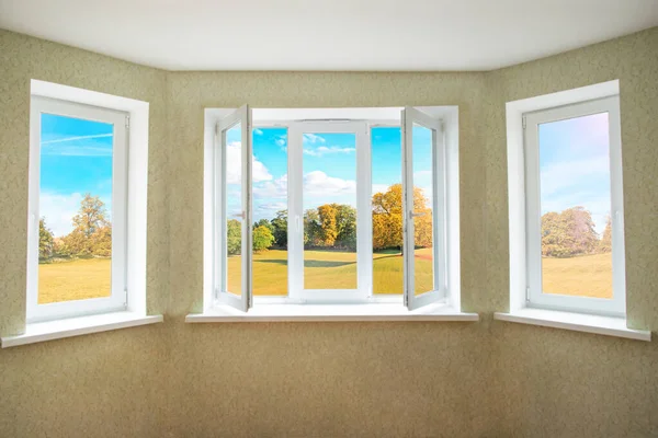 View through a opened modern PVC window onto beautiful autumn landscape — Stock Photo, Image