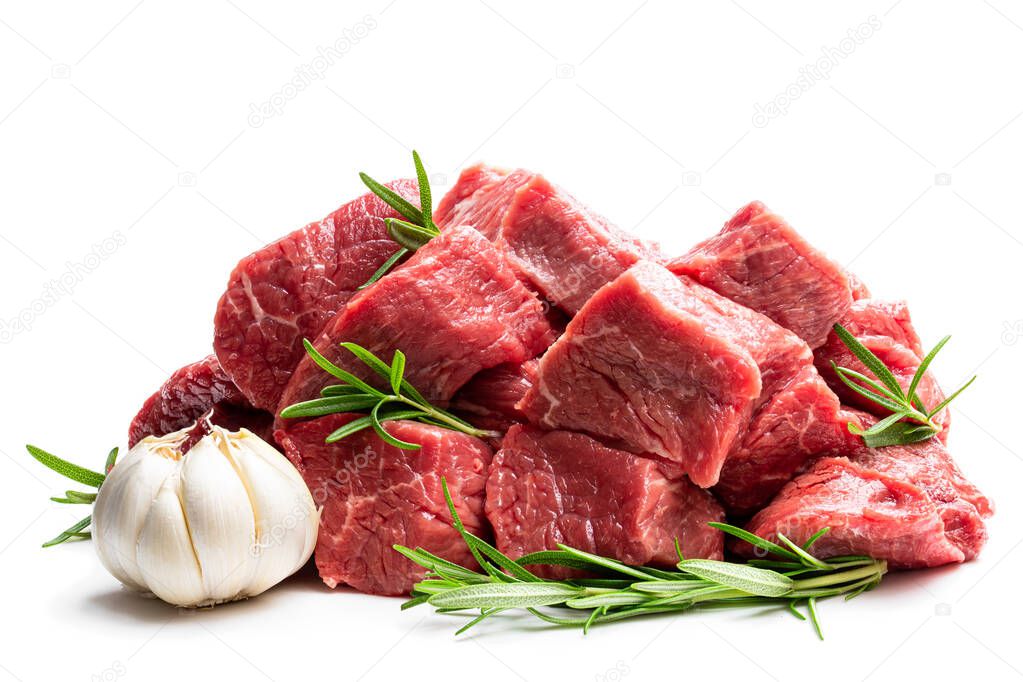 Sliced raw beef with rosemary herb and garlic isolated on white 