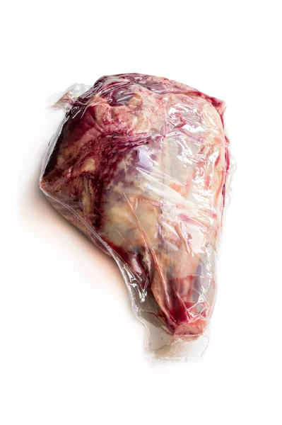 Vacuum pack of raw lamb leg isolated on white — Stock Photo, Image