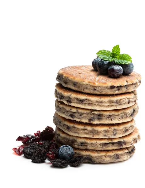 Stack  of welsh cakes with dry berries and fresh blueberries isolated on white