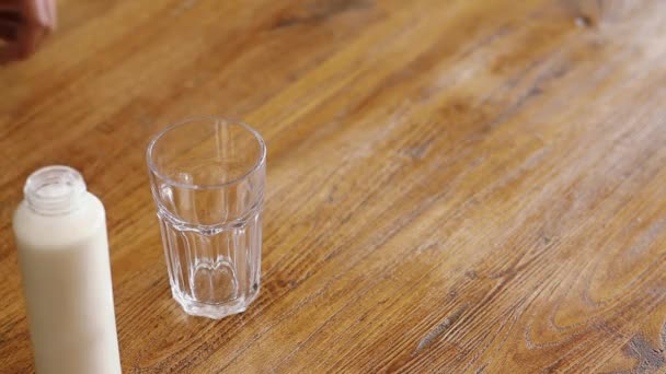 Pouring milk into glass Stock Footage