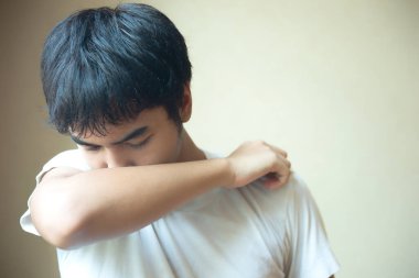 Hiperhidrozlu Asyalı genç adam koltuk altında terliyor.