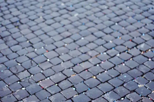 Full frame of paving stones on street road in selective focus