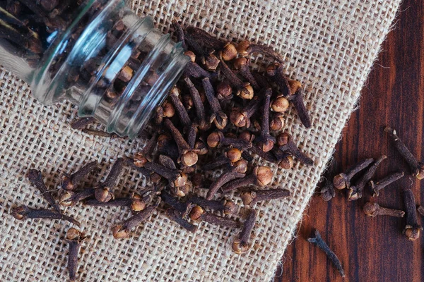 Cloves out of bottle container — Stock Photo, Image