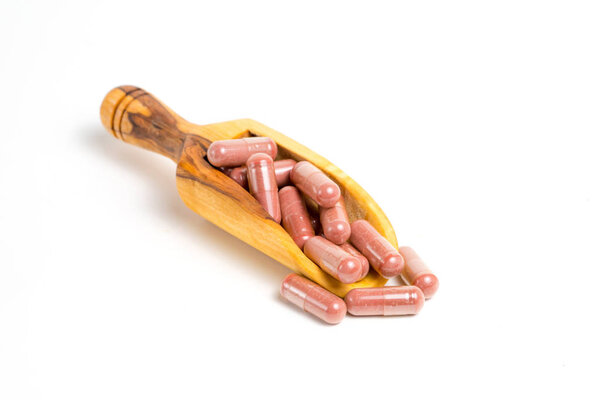 Red yeast rice supplement capsules on white background