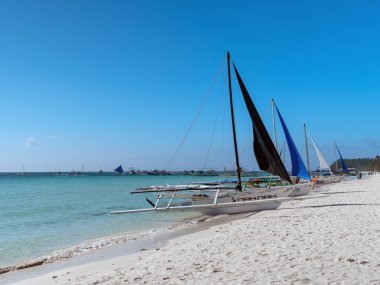 Boracay Island of Philippines. Feb 14, 2020: Paraw sailing boat docking on beach during bright day at Boracay Island of Philippines