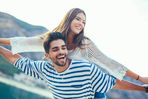 Young cheerful couple by the harbor — Stock Photo, Image