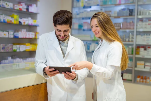 Apotheker nutzen digitales Tablet bei Medikamentenkontrolle in Apotheke — Stockfoto