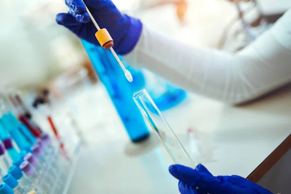 Woman collects forensic DNA sample stick in laboratory — Stock Photo, Image