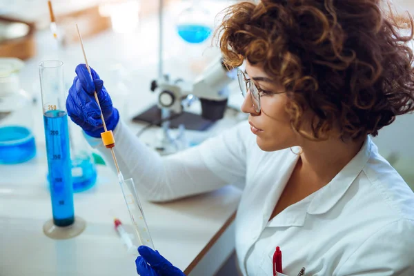 Woman collects forensic DNA sample stick in laboratory — Stock Photo, Image