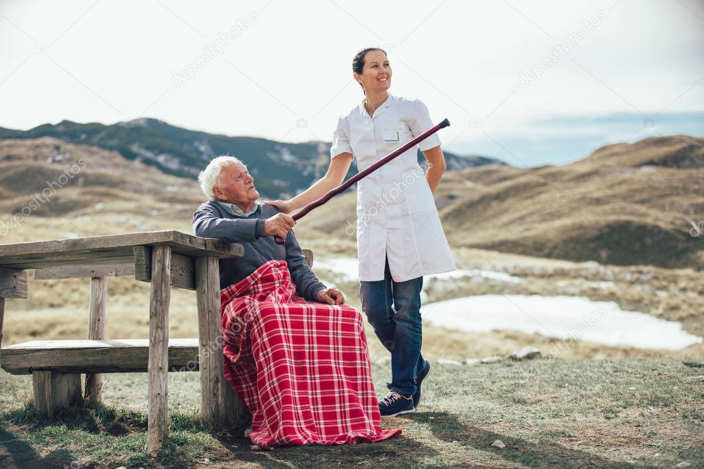 Nurse with elderly senior man