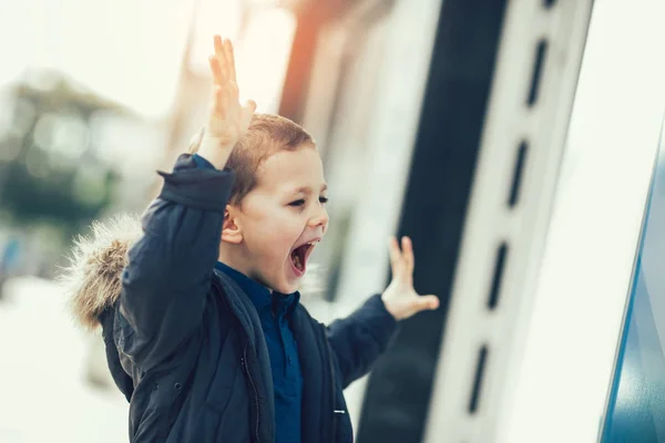 Excited little boy near shop — Stock Photo, Image