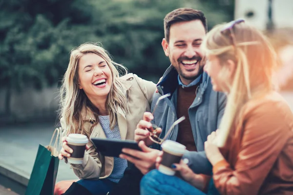 friends laughing using tablet