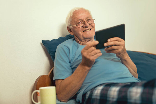 senior man using digital tablet 
