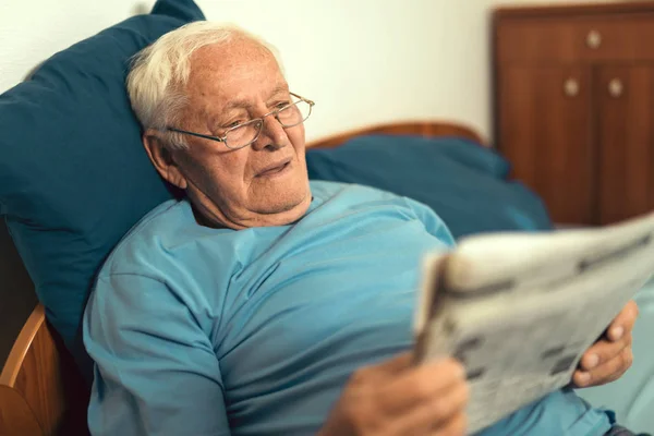 senior man reading newspaper