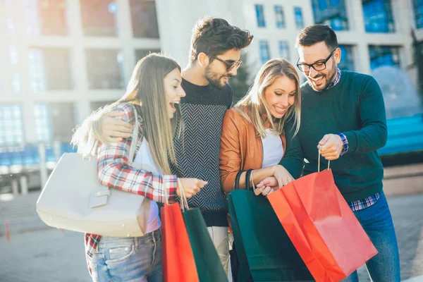 Gelukkige vrienden met shopping tassen — Stockfoto