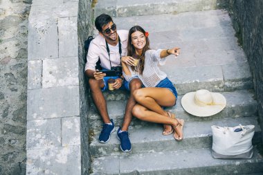 Merdivenlerde oturan ve tablet bilgisayar kullanarak Romantik Çift