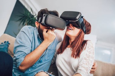 Genç erkek ve kadın sanal gerçeklik gözlük izlemek ve gösterilen rahat kıyafetler giymek Vr kamera, teknoloji ve İnovasyon kavramı düşünün